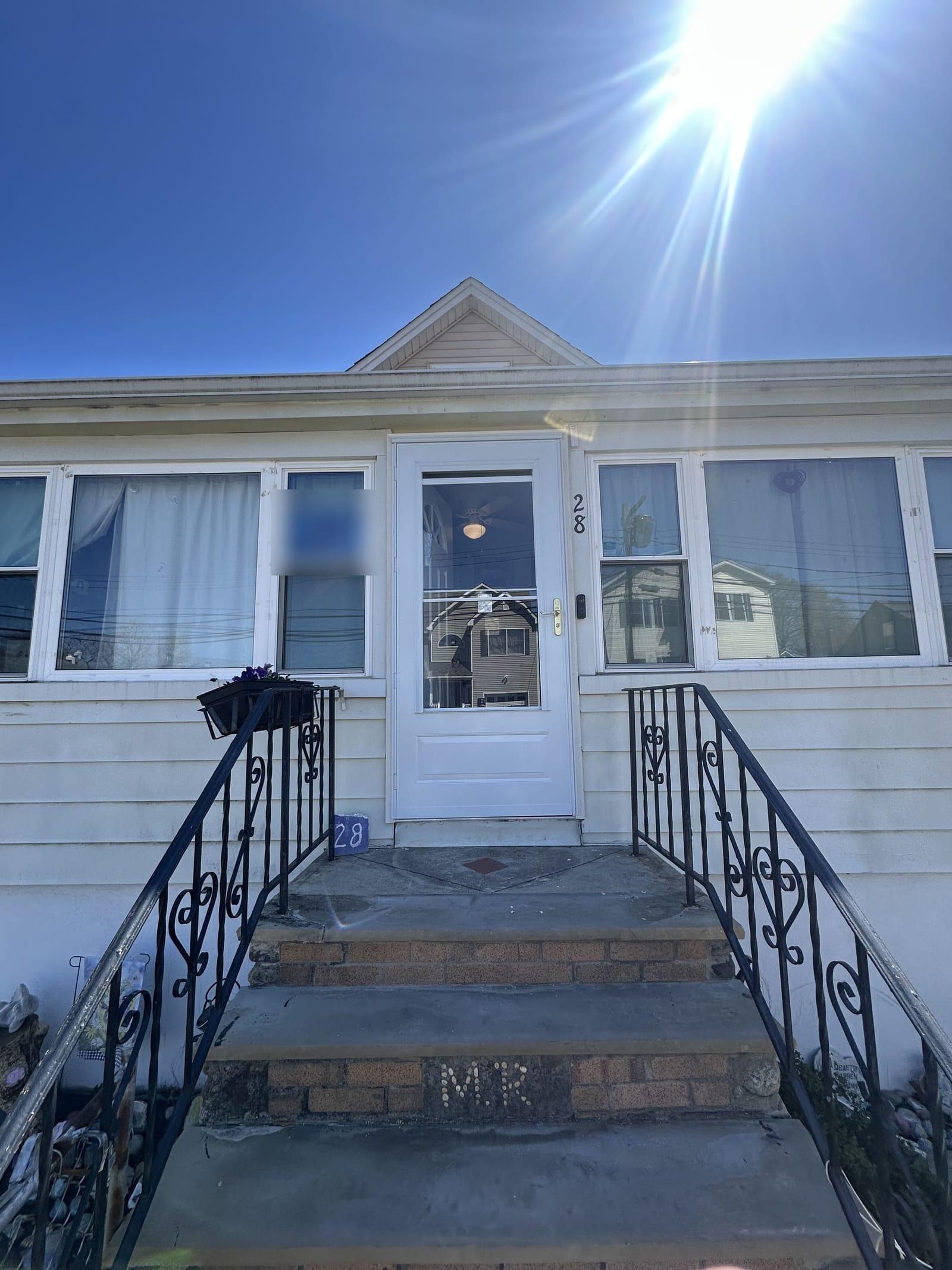 Finished entry with new storm door installed over replacement entry door